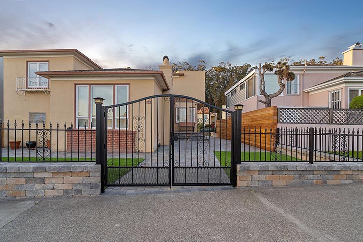 Iron fence and gate dramatically enhances a house.