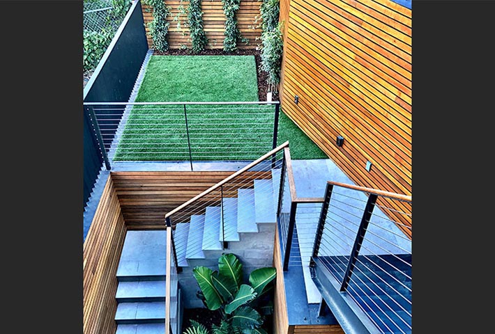 Landscaping for modern appartment patio with wooden and metal structures for grass and plants in Sam Francisco