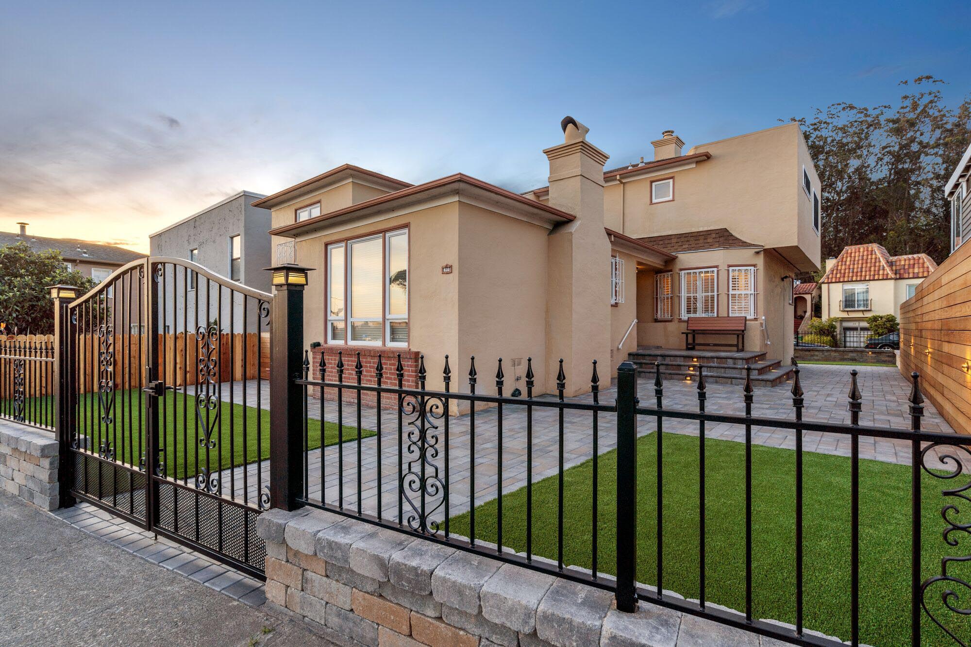 Iron fence and gate, stone pavers entrance and stone steps in a beautiful San Francisco home.
