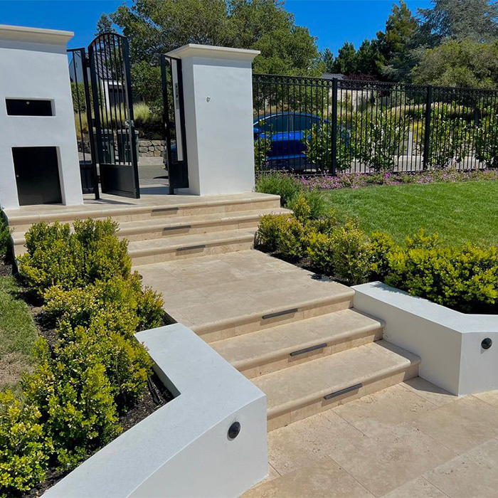 Elegant estate entrance with classic steps and iron doors