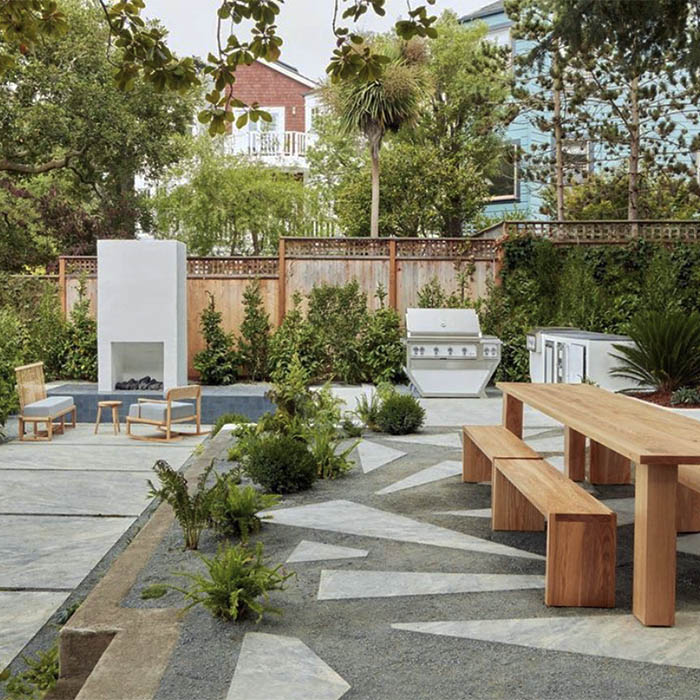 Hardscaping including fireplace, concrete pathways, grill, tables and chairs matching the San Francisco city modern style.